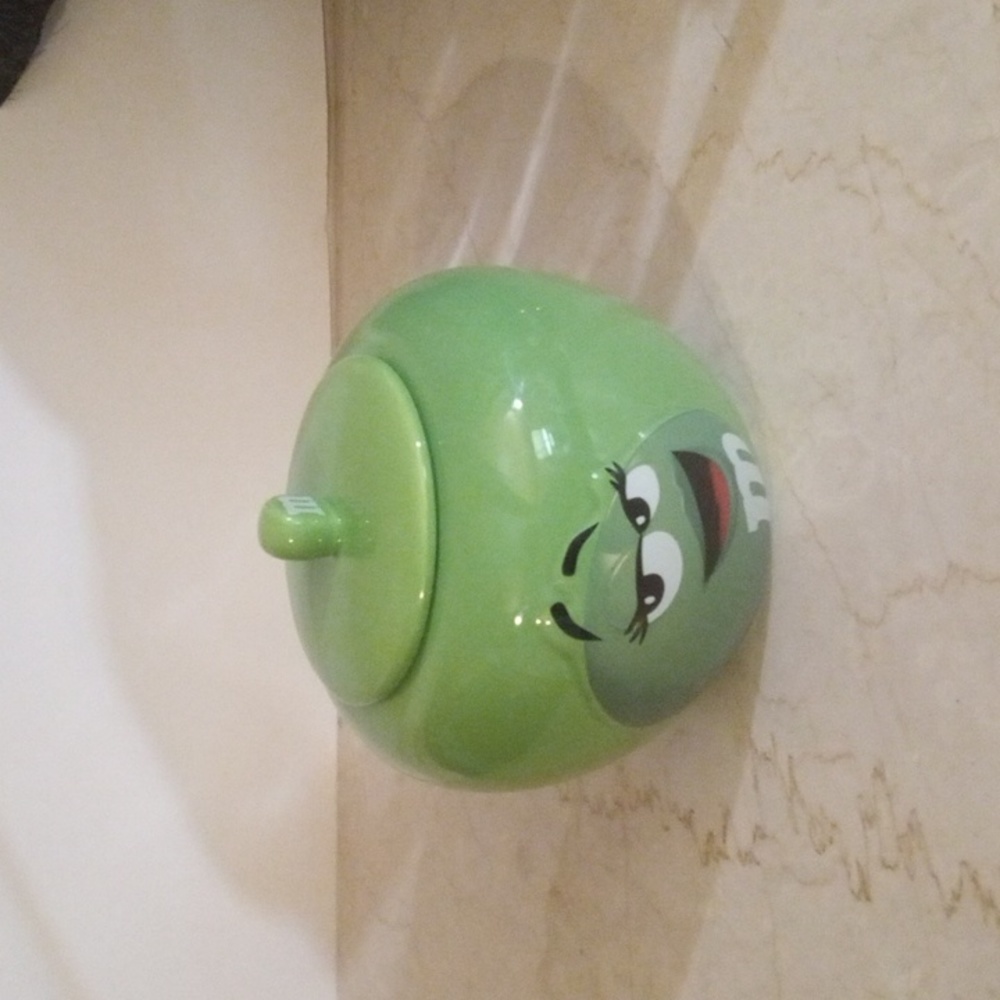 A M&M green canister. It can hold a variety of things. Cookies, Candy, Keys.